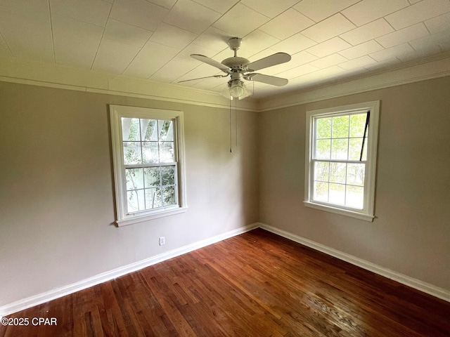 4276 2nd Ave, Marianna, FL 32446 - spare room with dark wood-type flooring, baseboards, ceiling fan, and crown molding