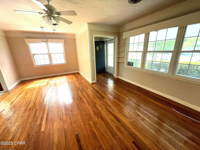 4276 2nd Ave, Marianna, FL 32446 - unfurnished room with ornamental molding, baseboards, a ceiling fan, and wood-type flooring