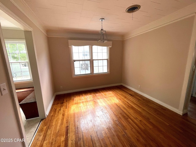 4276 2nd Ave, Marianna, FL 32446 - empty room featuring wood-type flooring, crown molding, and baseboards