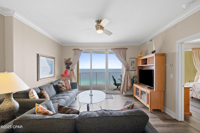17545 Front Beach Rd Unit 1705, Panama City Beach, FL 32413 - living area with wood finished floors, a ceiling fan, crown molding, and baseboards