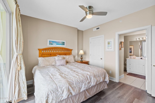 17545 Front Beach Rd Unit 1705, Panama City Beach, FL 32413 - bedroom featuring wood finished floors, ensuite bathroom, baseboards, and ceiling fan