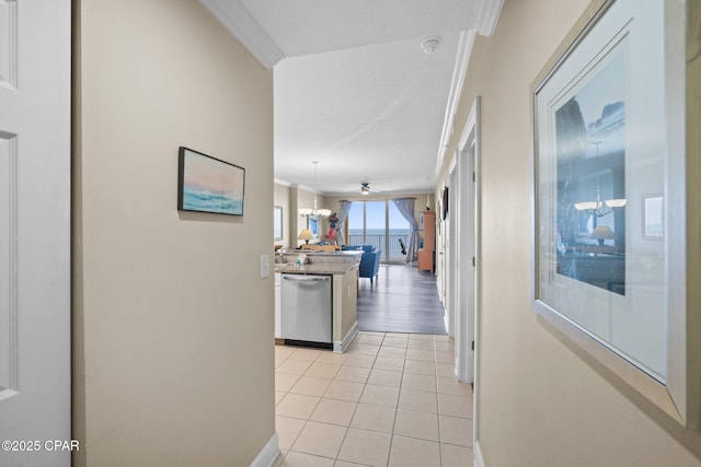 17545 Front Beach Rd Unit 1705, Panama City Beach, FL 32413 - hallway featuring crown molding, light tile patterned floors, and baseboards