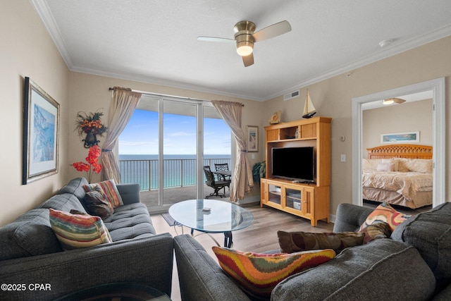 17545 Front Beach Rd Unit 1705, Panama City Beach, FL 32413 - living room featuring a ceiling fan, wood finished floors, and ornamental molding