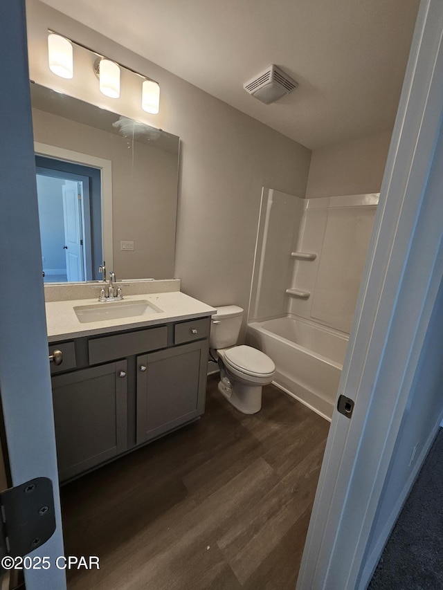 237 Skylah Ln Unit 19, Panama City Beach, FL 32407 - bathroom with vanity, toilet, wood finished floors, and shower / washtub combination