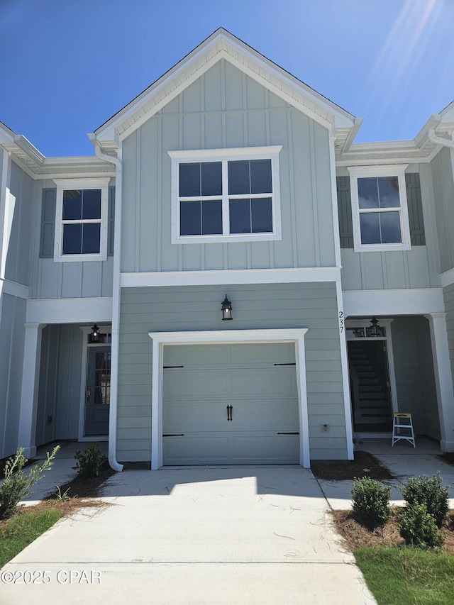 237 Skylah Ln Unit 19, Panama City Beach, FL 32407 - view of front of property with board and batten siding, a garage, and concrete driveway