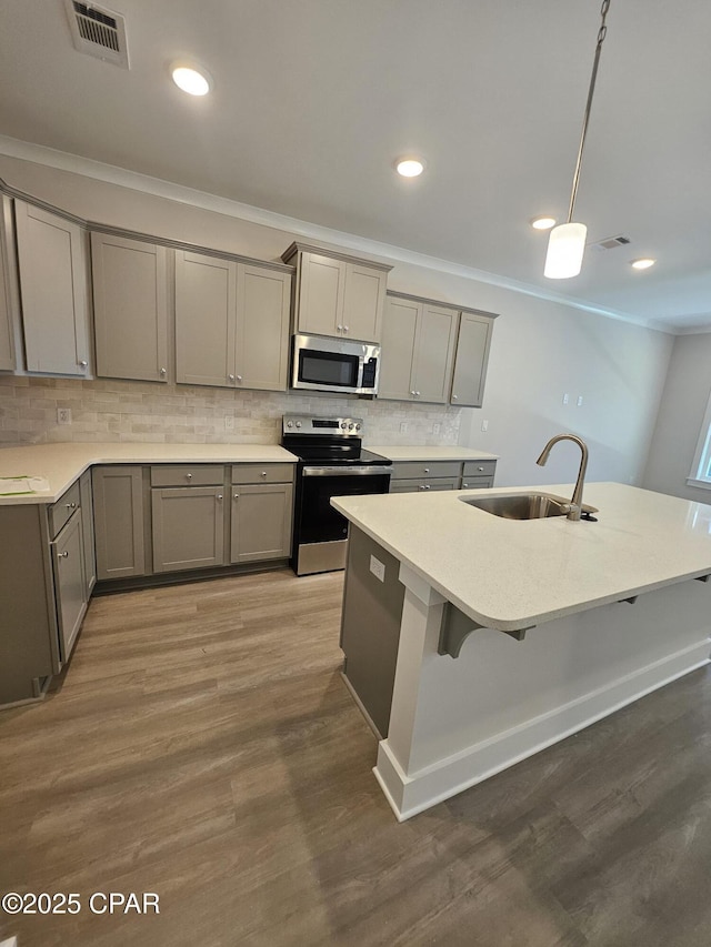 237 Skylah Ln Unit 19, Panama City Beach, FL 32407 - kitchen featuring appliances with stainless steel finishes, a sink, gray cabinets, tasteful backsplash, and recessed lighting