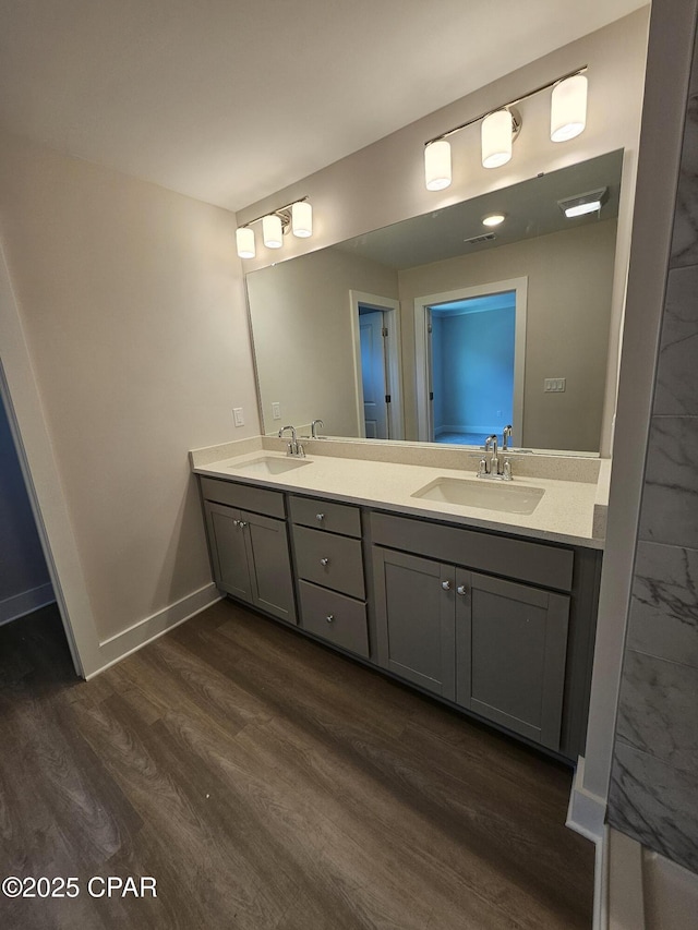 237 Skylah Ln Unit 19, Panama City Beach, FL 32407 - bathroom featuring wood finished floors, double vanity, and baseboards