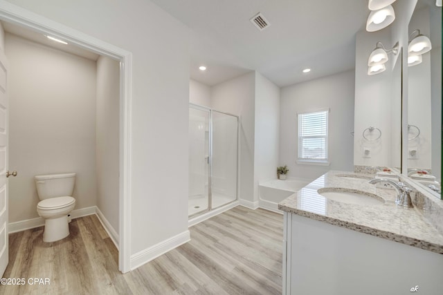 4862 Sweetspire Dr, Panama City, FL 32404 - bathroom with wood finished floors, a shower stall, double vanity, a bath, and recessed lighting