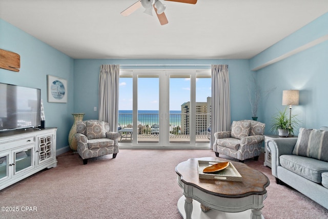 9860 S Thomas Dr Unit 802, Panama City, FL 32408 - carpeted living area with a ceiling fan and a water view