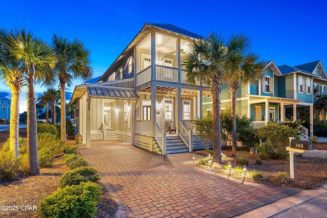 view of front of property with board and batten siding and a balcony