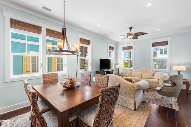 dining area featuring a chandelier, recessed lighting, dark wood-type flooring, baseboards, and ornamental molding