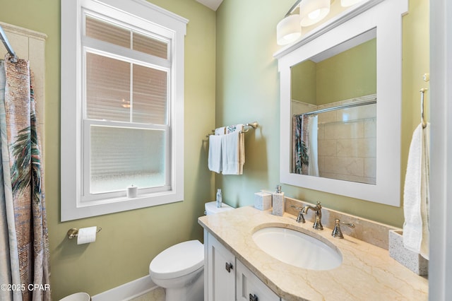 bathroom featuring toilet, vanity, baseboards, and a shower with shower curtain