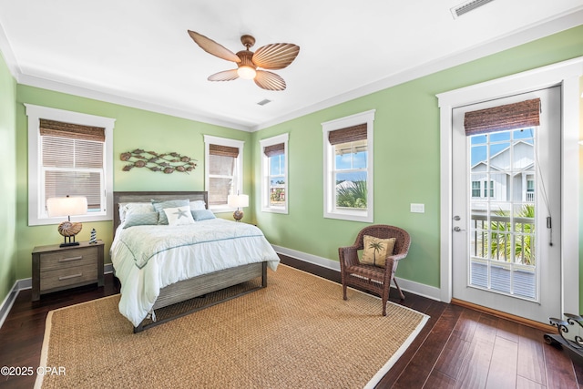 bedroom with access to outside, multiple windows, and baseboards