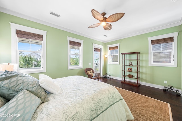 bedroom with wood finished floors, baseboards, ornamental molding, and a ceiling fan