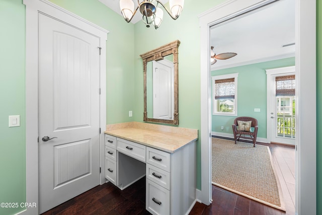 bathroom featuring hardwood / wood-style flooring, a chandelier, vanity, and baseboards