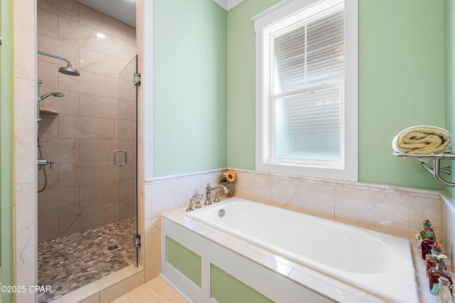 bathroom featuring a stall shower and a bath