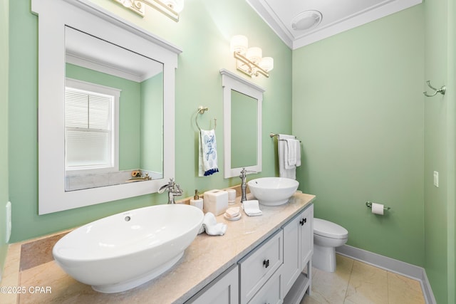 bathroom with crown molding, toilet, double vanity, baseboards, and marble finish flooring