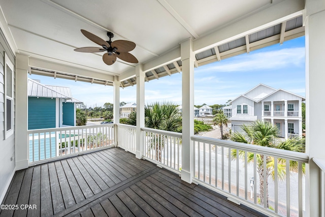 wooden deck with ceiling fan and a residential view