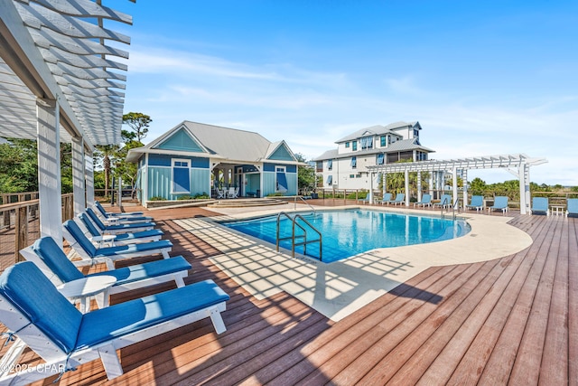 community pool featuring a pergola, a deck, a patio, and fence