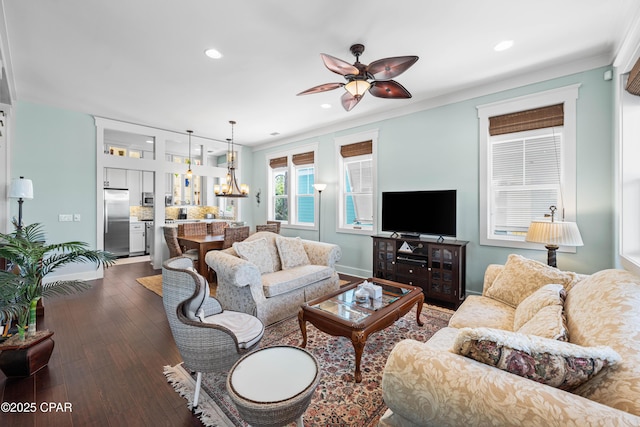 living area with recessed lighting, dark wood-style flooring, ceiling fan, crown molding, and a chandelier
