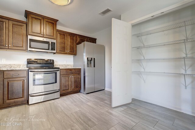 3549 Azalea Way, Panama City, FL 32405 - kitchen with stainless steel appliances, baseboards, and light stone countertops