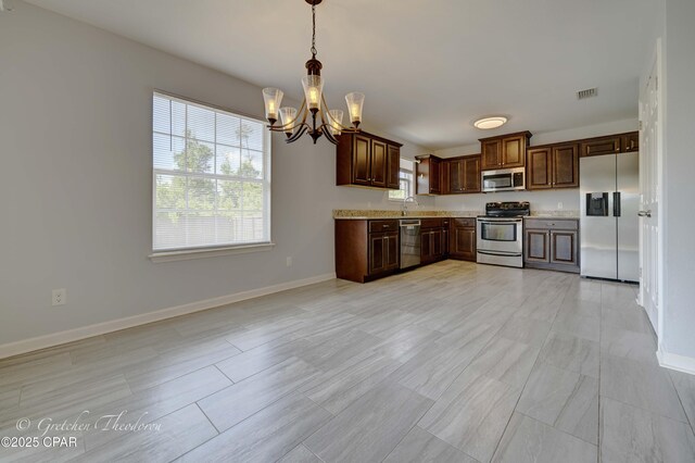3549 Azalea Way, Panama City, FL 32405 - kitchen featuring stainless steel appliances, a chandelier, light countertops, and healthy amount of natural light