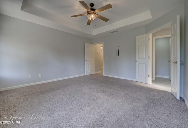 3549 Azalea Way, Panama City, FL 32405 - empty room featuring a raised ceiling, ceiling fan, carpet floors, and baseboards