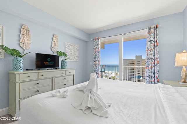 bedroom with baseboards and access to exterior
