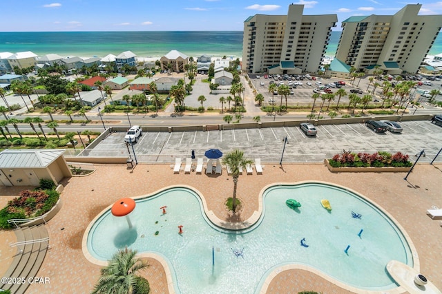 bird's eye view of a nearby body of water and a pool