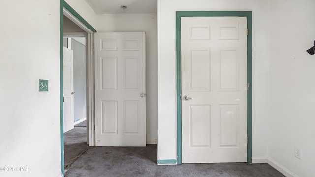unfurnished bedroom with carpet and baseboards