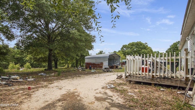 view of yard with a carport and driveway