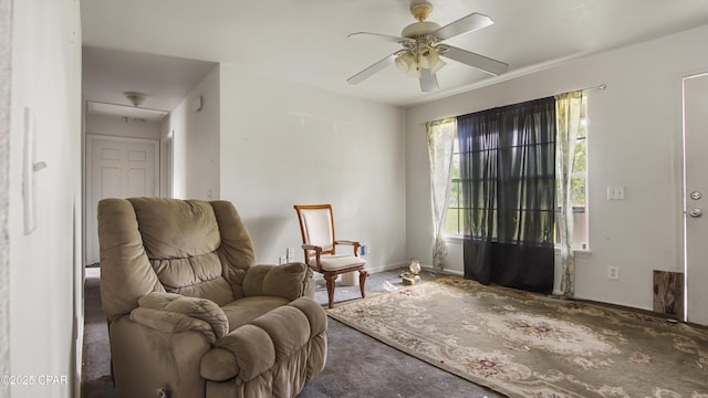 sitting room with carpet, ceiling fan, and baseboards
