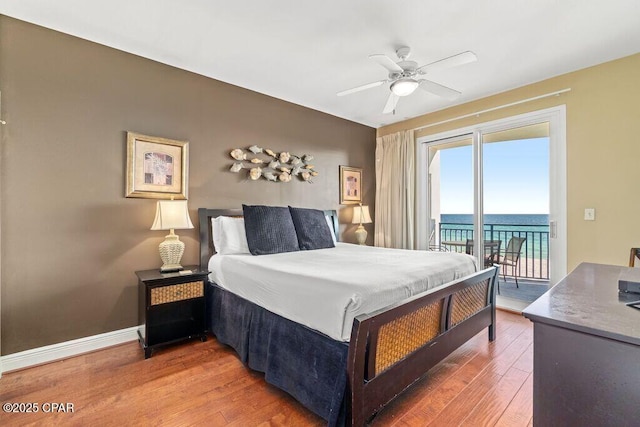 16701 Front Beach Rd Unit 306, Panama City Beach, FL 32413 - bedroom with access to outside, wood finished floors, a ceiling fan, and a water view