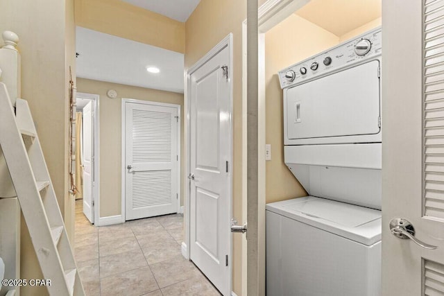16701 Front Beach Rd Unit 306, Panama City Beach, FL 32413 - laundry area featuring stacked washer / dryer, light tile patterned flooring, recessed lighting, and baseboards