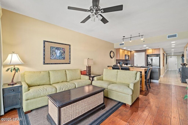 16701 Front Beach Rd Unit 306, Panama City Beach, FL 32413 - living area featuring wood finished floors, a ceiling fan, baseboards, and rail lighting