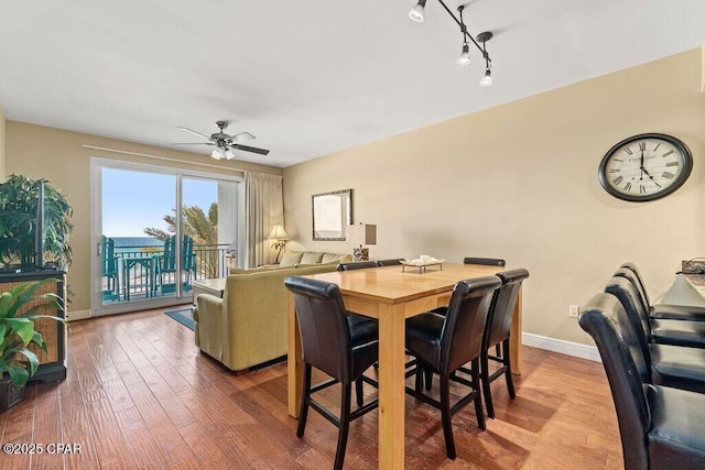 16701 Front Beach Rd Unit 306, Panama City Beach, FL 32413 - dining room with wood finished floors, a ceiling fan, and baseboards