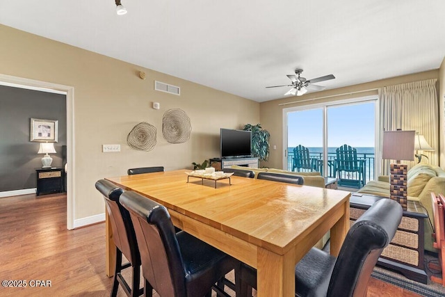 16701 Front Beach Rd Unit 306, Panama City Beach, FL 32413 - dining space featuring light wood-style flooring, a ceiling fan, and baseboards