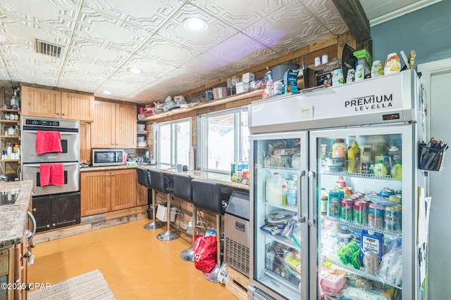 2322 Silversides Loop, Pensacola, FL 32526 - kitchen featuring stainless steel appliances, open shelves, an ornate ceiling, and light stone counters