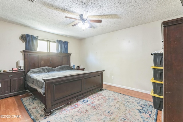 2322 Silversides Loop, Pensacola, FL 32526 - bedroom featuring wood finished floors, a textured ceiling, ceiling fan, and baseboards