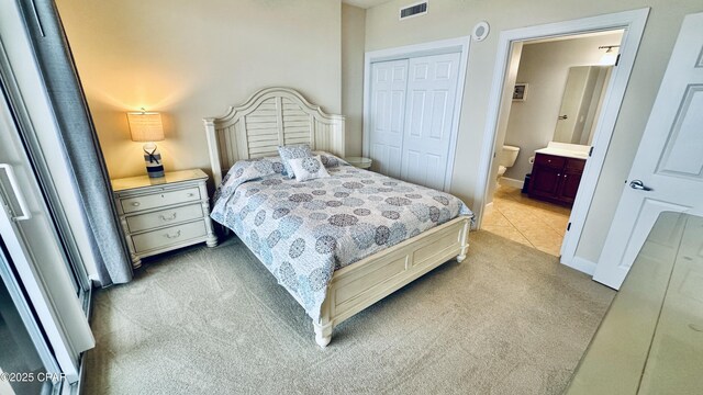 17643 Front Beach Rd Unit 1704, Panama City Beach, FL 32413 - bedroom featuring light colored carpet, a closet, ensuite bathroom, and baseboards