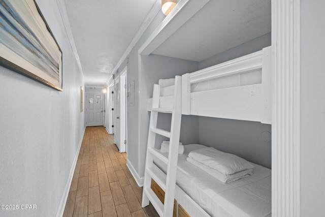 8743 Thomas Dr Unit 1211, Panama City Beach, FL 32408 - bedroom featuring wood finished floors and baseboards