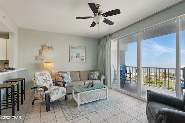 1515 SE Miracle Strip Pkwy Unit 609, Fort Walton Beach, FL 32548 - living room featuring light tile patterned flooring, a water view, and a ceiling fan