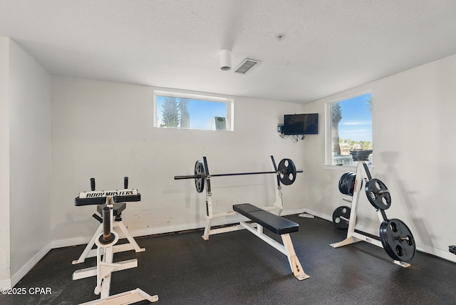 1515 SE Miracle Strip Pkwy Unit 609, Fort Walton Beach, FL 32548 - workout room featuring baseboards and a textured ceiling
