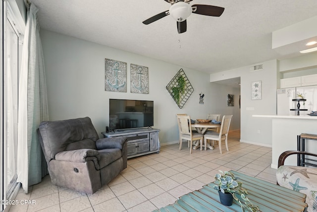 1515 SE Miracle Strip Pkwy Unit 609, Fort Walton Beach, FL 32548 - living room featuring a ceiling fan, baseboards, and light tile patterned flooring