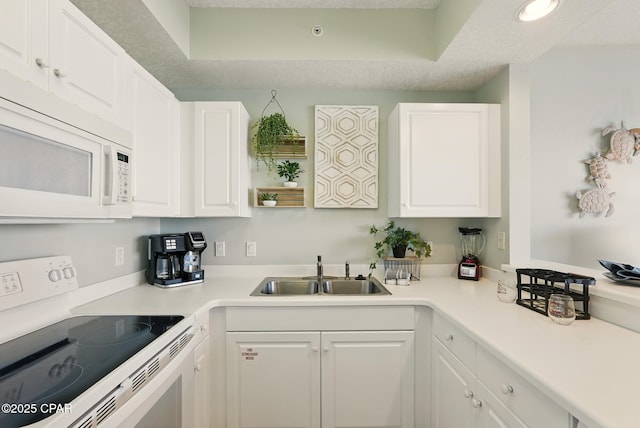1515 SE Miracle Strip Pkwy Unit 609, Fort Walton Beach, FL 32548 - kitchen with white appliances, a sink, white cabinetry, and a tray ceiling