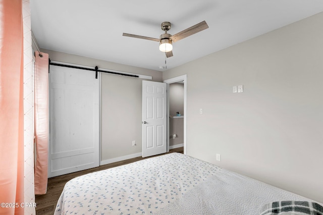 710 Legion Dr Unit O4, Destin, FL 32541 - bedroom featuring wood finished floors, a barn door, a closet, ceiling fan, and baseboards