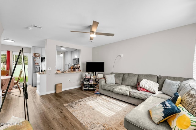 710 Legion Dr Unit O4, Destin, FL 32541 - living area with wood finished floors, a ceiling fan, and baseboards