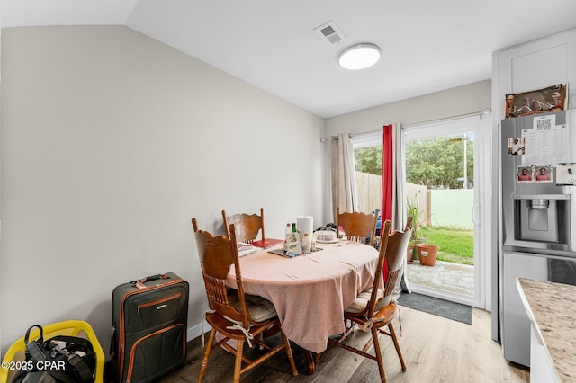 710 Legion Dr Unit O4, Destin, FL 32541 - dining space with light wood-style floors and lofted ceiling