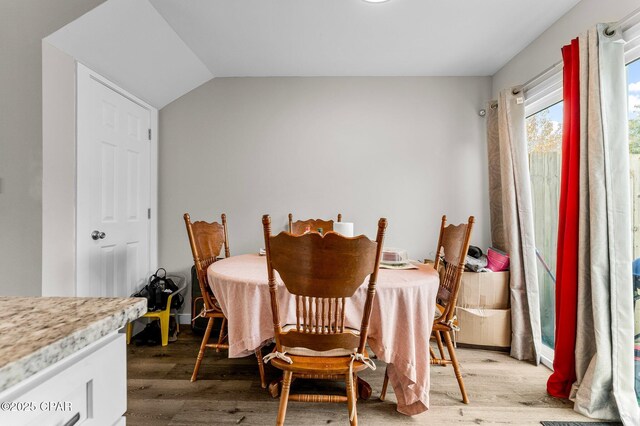 710 Legion Dr Unit O4, Destin, FL 32541 - dining space with light wood-style flooring and vaulted ceiling