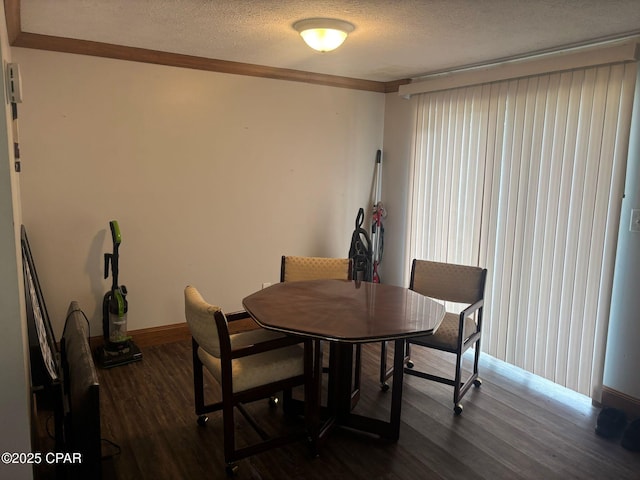 6507 Winona St, Panama City, FL 32404 - dining room with dark wood-style flooring, baseboards, a textured ceiling, and crown molding